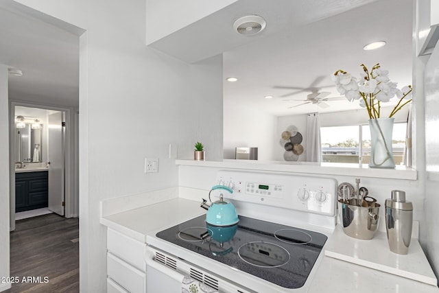 kitchen with recessed lighting, visible vents, electric stove, light countertops, and dark wood-style floors