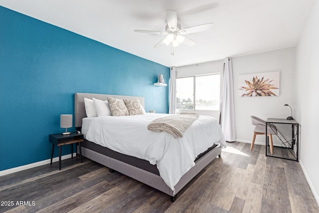 bedroom featuring ceiling fan, baseboards, and wood finished floors