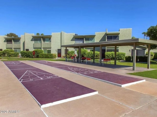 view of home's community featuring shuffleboard