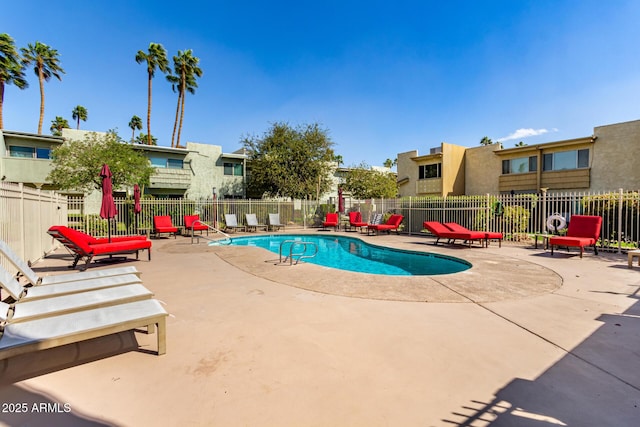 community pool with fence and a patio