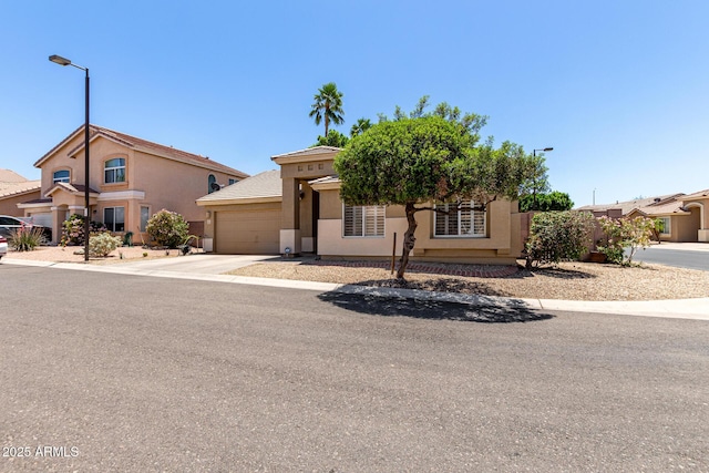 6631 E Rhodes St, Mesa, AZ 85215 - view of front of property with an attached garage, stucco siding, and concrete driveway