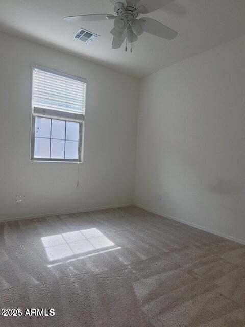 empty room with carpet floors and ceiling fan