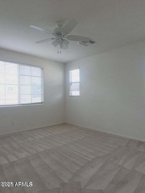 spare room featuring carpet flooring and ceiling fan