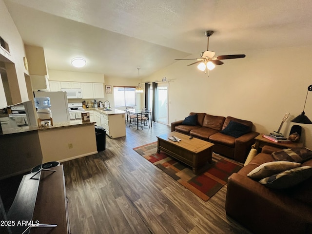 living room with a ceiling fan, dark wood finished floors, and vaulted ceiling