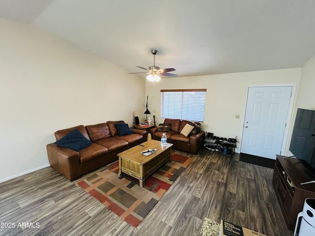 living room featuring ceiling fan, baseboards, and wood finished floors