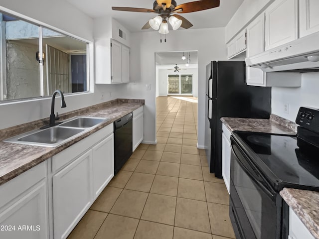 kitchen featuring custom exhaust hood, black appliances, sink, light tile patterned floors, and white cabinetry