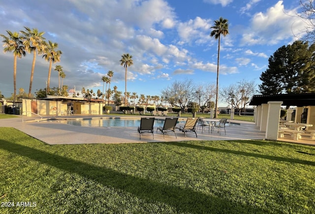 view of pool with a lawn