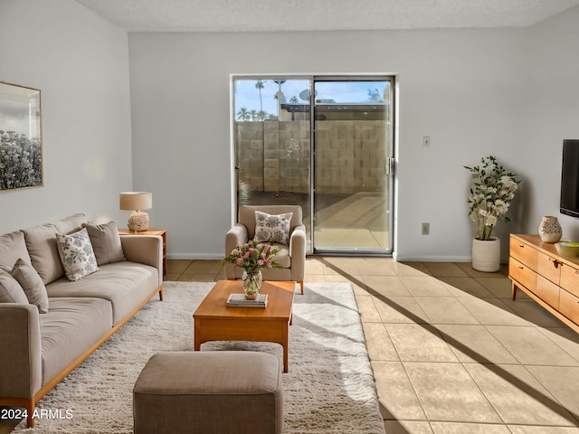 tiled living room featuring a textured ceiling