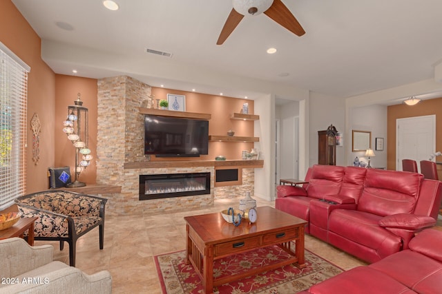 living room with a fireplace and ceiling fan