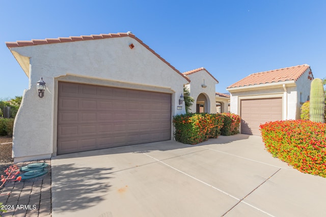 mediterranean / spanish house with a garage