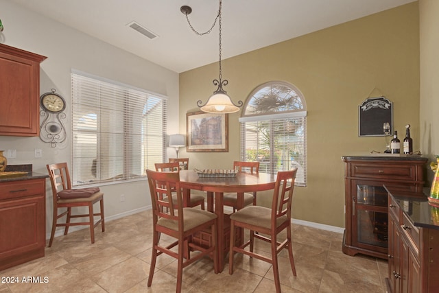 dining room with light tile patterned floors and a healthy amount of sunlight