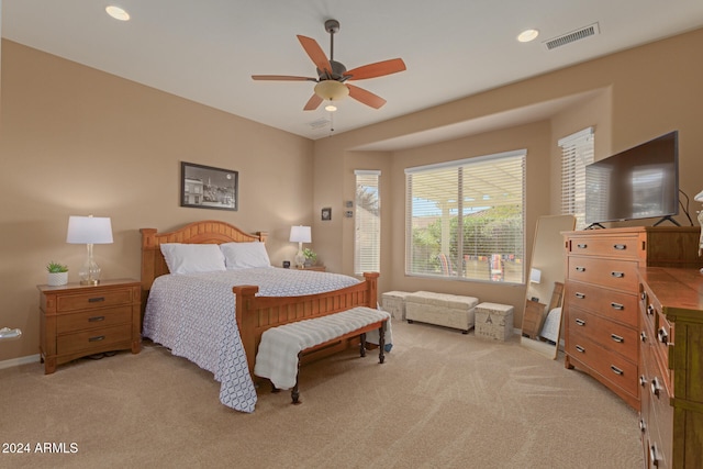 bedroom featuring light carpet and ceiling fan