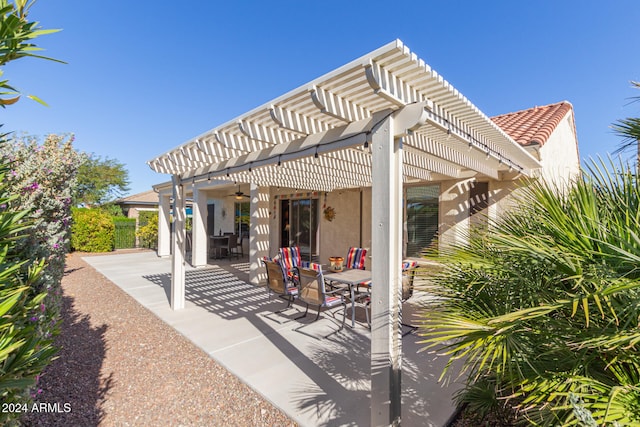 view of patio / terrace featuring ceiling fan and a pergola