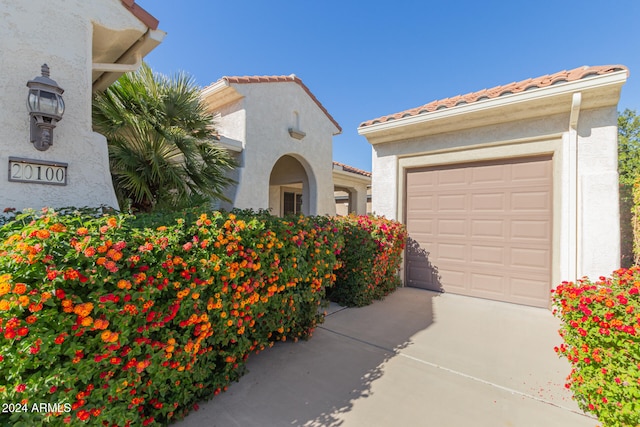 mediterranean / spanish home with a garage