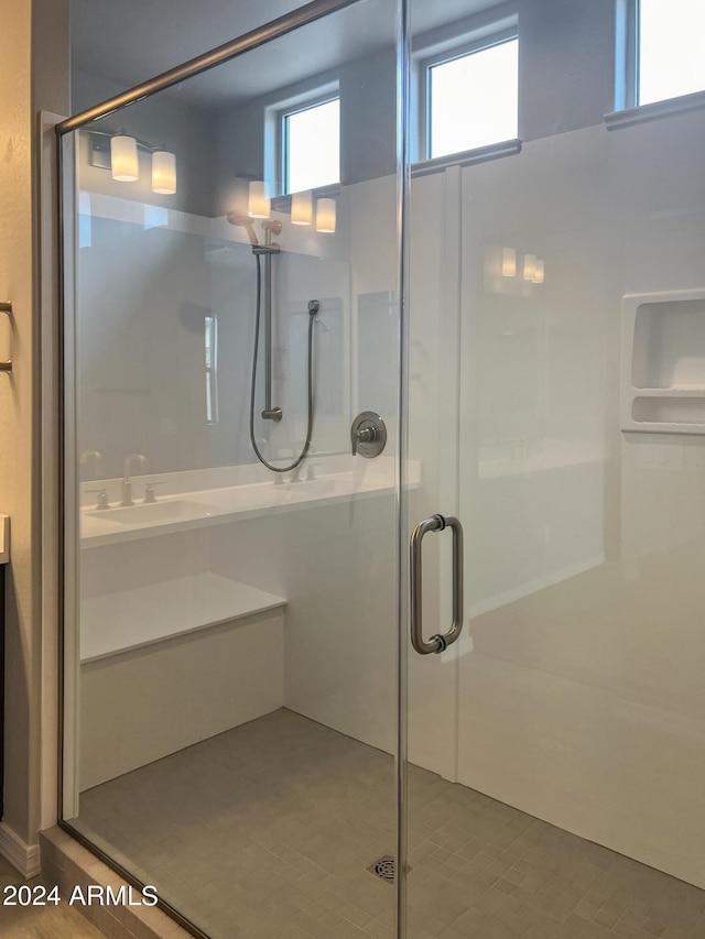 bathroom featuring a shower with door