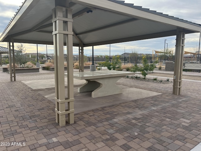 view of patio featuring fence and a gazebo