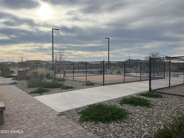 view of tennis court featuring fence