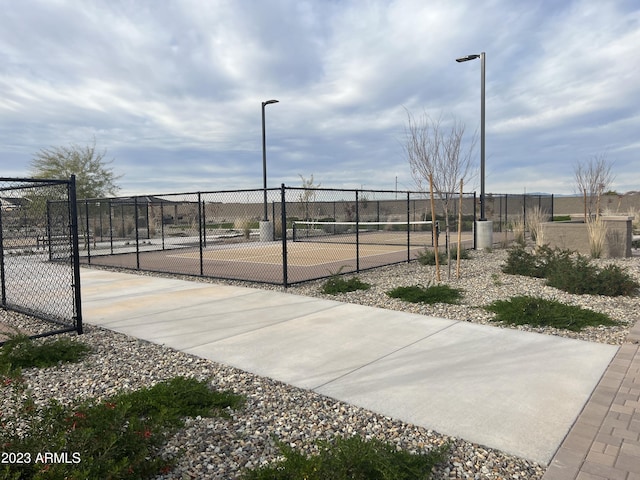 view of community featuring tennis court