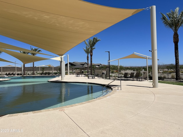 pool featuring a patio and fence