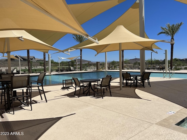 pool featuring a patio area and fence