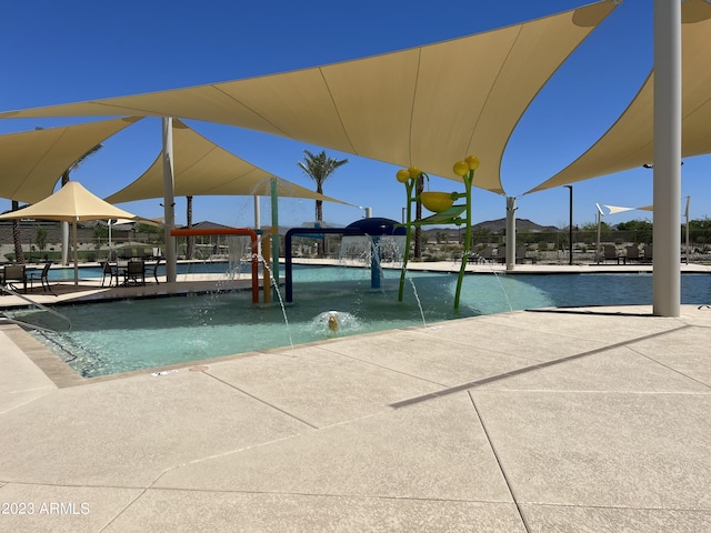 view of swimming pool with pool water feature