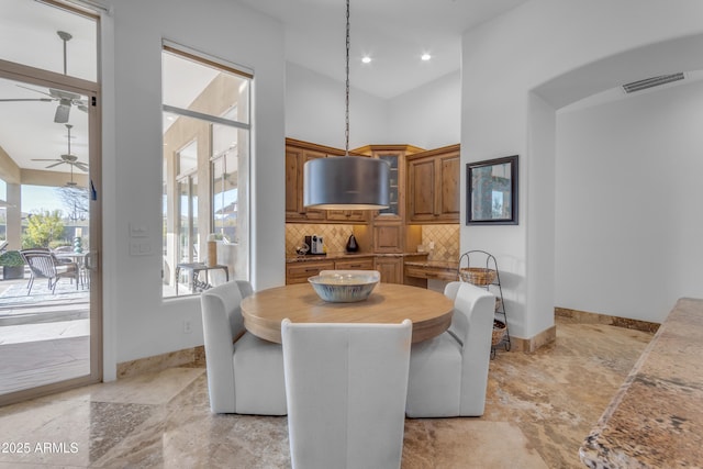 dining area featuring recessed lighting, visible vents, a towering ceiling, ceiling fan, and baseboards