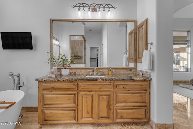 bathroom featuring a freestanding tub and vanity