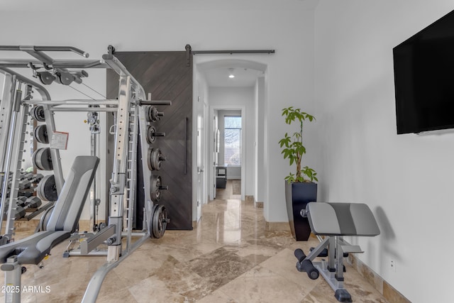 workout area with marble finish floor and baseboards