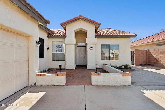 mediterranean / spanish-style house with a garage