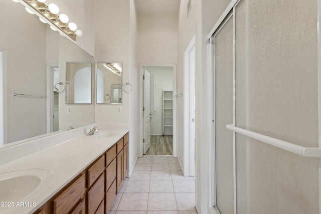 bathroom featuring vanity, tile patterned floors, and a shower with shower door