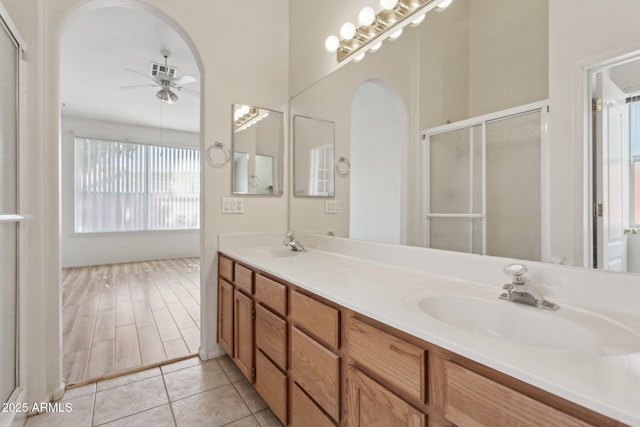 bathroom featuring tile patterned flooring, vanity, ceiling fan, and a shower with shower door