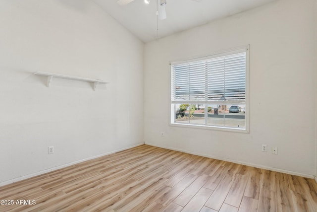 empty room featuring lofted ceiling, ceiling fan, and light hardwood / wood-style flooring