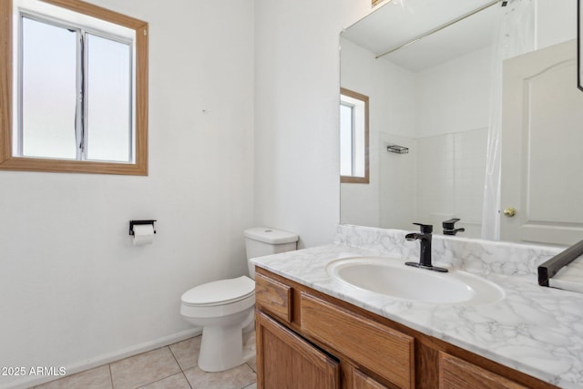 bathroom featuring vanity, a shower, tile patterned floors, and toilet