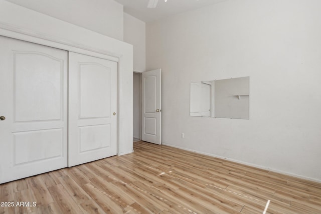 unfurnished bedroom featuring light hardwood / wood-style floors and a closet