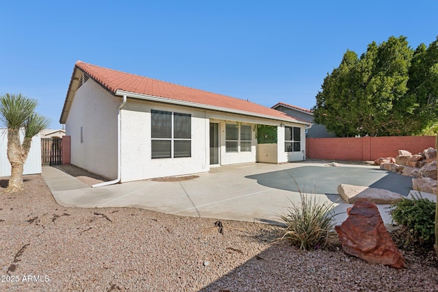 back of property featuring a patio