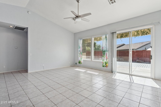 tiled empty room with vaulted ceiling and ceiling fan