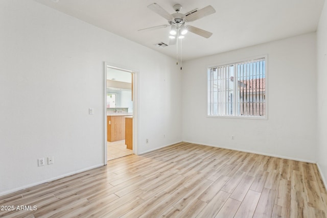 spare room with light hardwood / wood-style flooring and ceiling fan