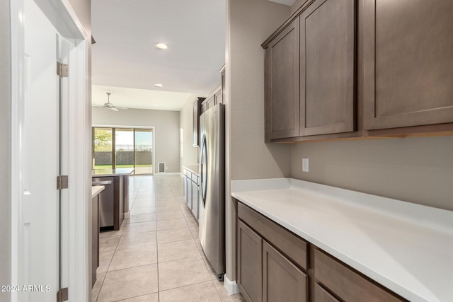 kitchen featuring appliances with stainless steel finishes, light tile patterned floors, and ceiling fan