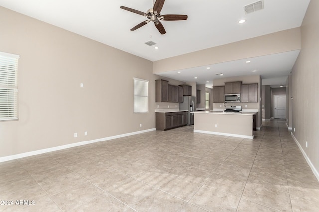 unfurnished living room with ceiling fan and light tile patterned flooring