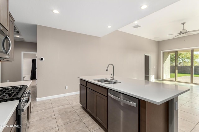 kitchen with dark brown cabinetry, ceiling fan, sink, an island with sink, and appliances with stainless steel finishes