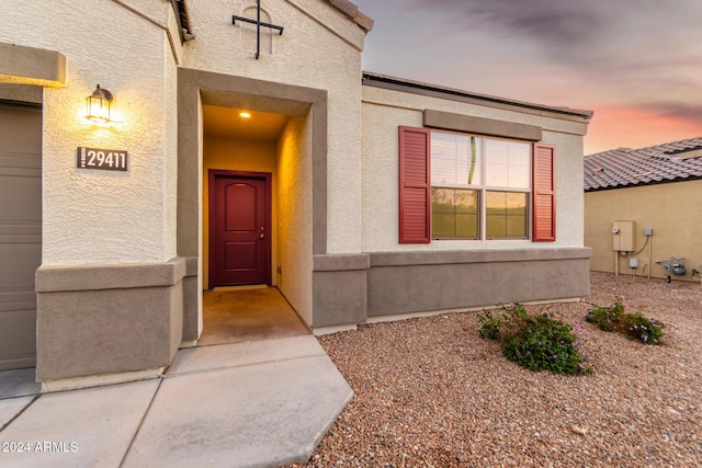 exterior entry at dusk with a garage