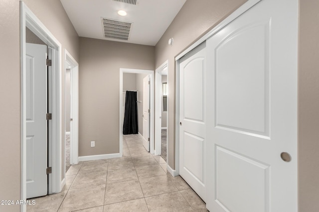 hall featuring light tile patterned floors