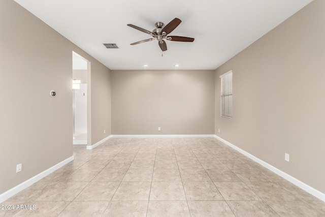 spare room featuring light tile patterned floors and ceiling fan