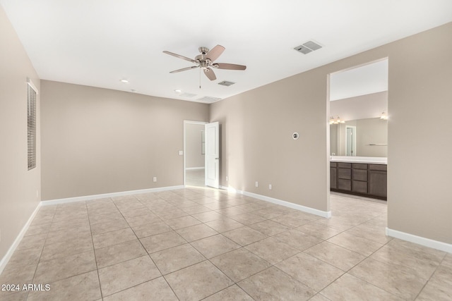 tiled empty room with ceiling fan