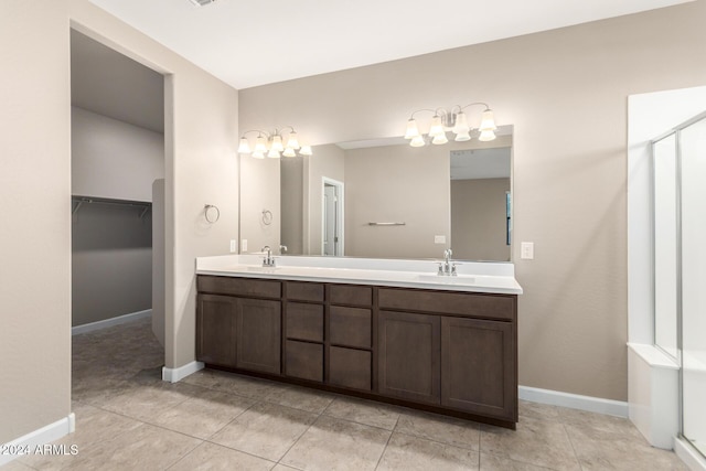 bathroom featuring tile patterned floors, vanity, and a shower with shower door