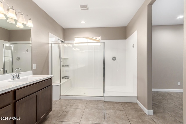 bathroom with tile patterned floors, vanity, and an enclosed shower