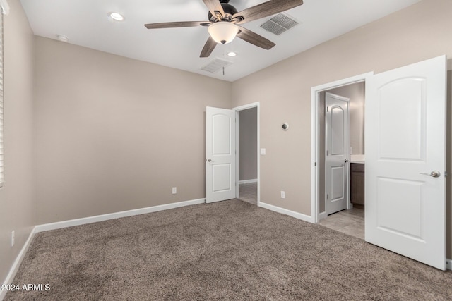 unfurnished bedroom with ceiling fan and light colored carpet