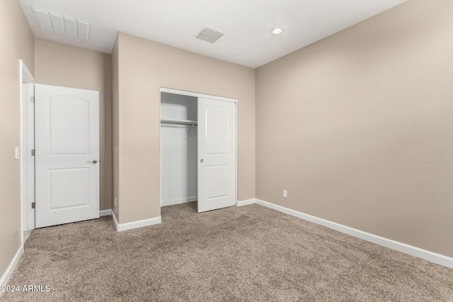 unfurnished bedroom with carpet floors and a closet