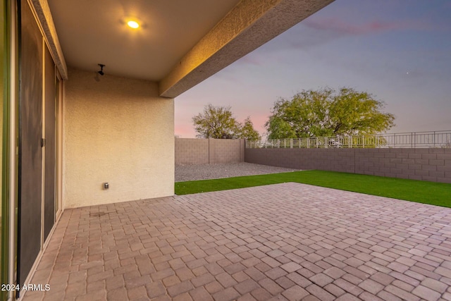 view of patio terrace at dusk