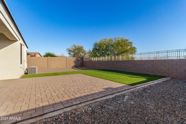 view of yard featuring a patio and central AC unit